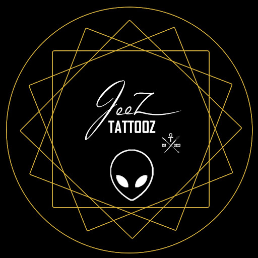 Jeez Tattooz logo on black with gold geometric rings, white lettering, an alien-head symbol and a small EST 2020 mark